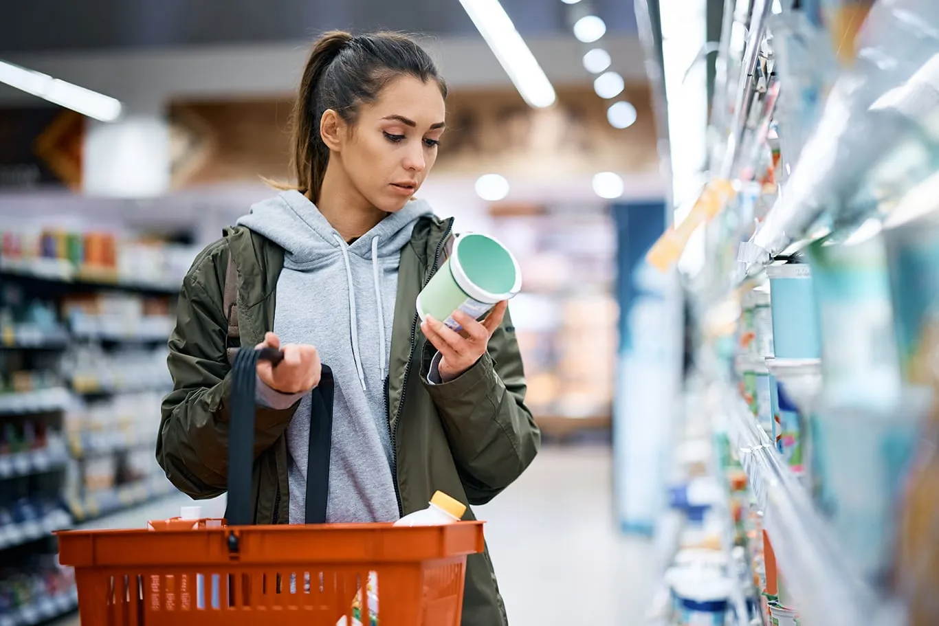 woman looking at nutrition label in store